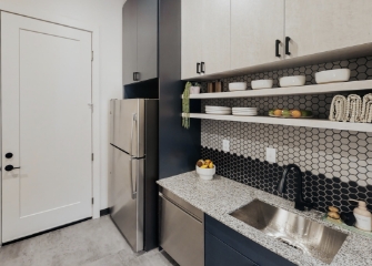 galley kitchen sink and fridge